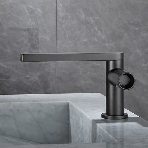 Gunmetal grey 360-degree swivel basin tap in the low configuration beside a basin