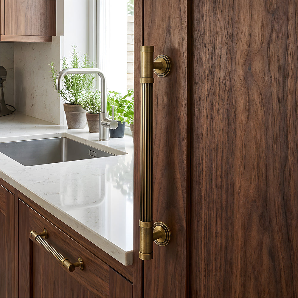 Striped antique bronze brass cabinet pulls installed on cupboards and drawers