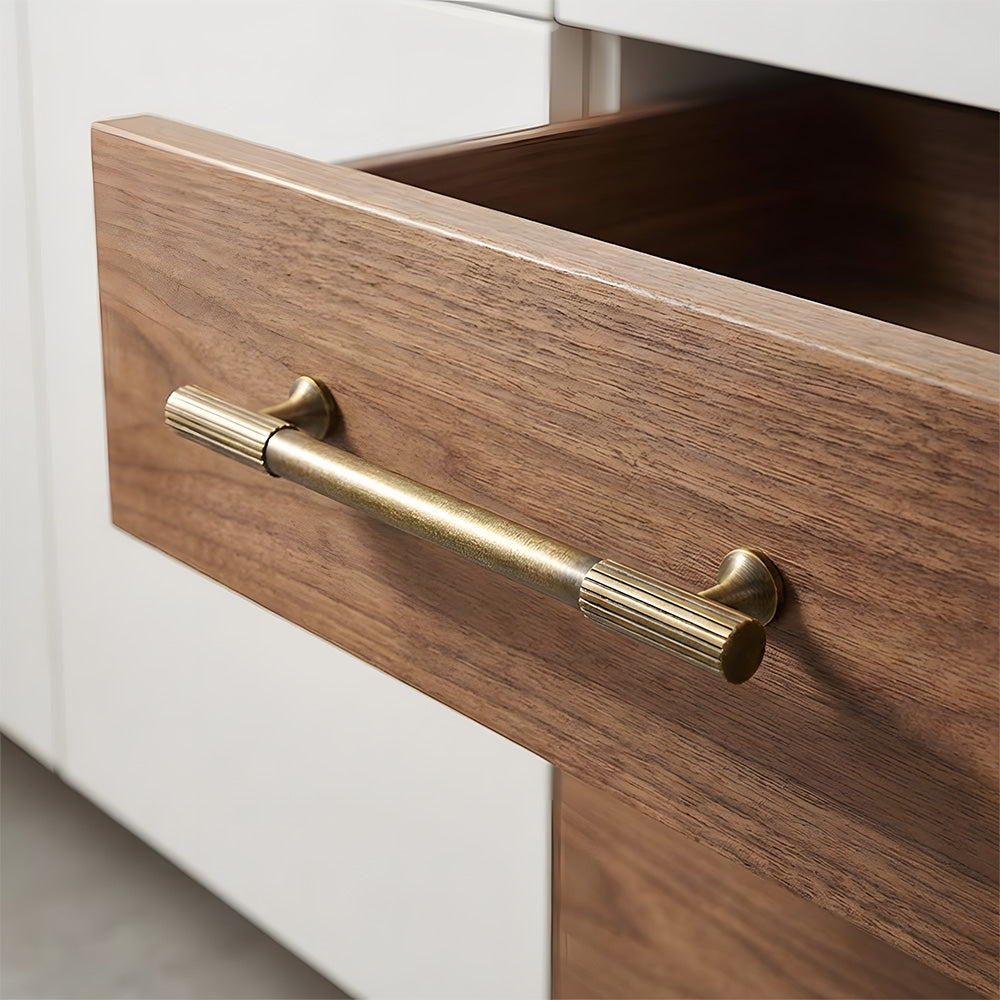Antique bronze striped brass handle fitted to a wooden drawer