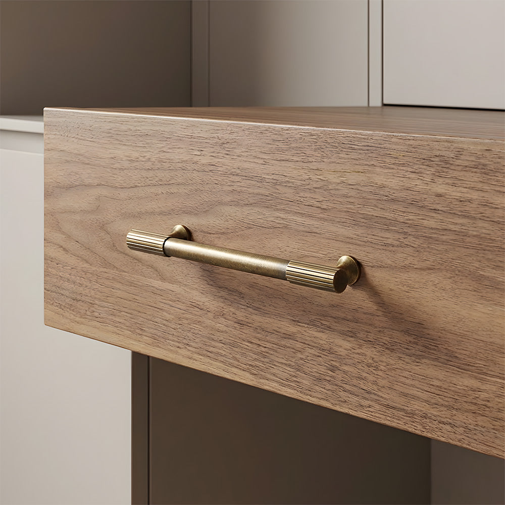 Antique bronze striped brass handle fitted to a light wood drawer