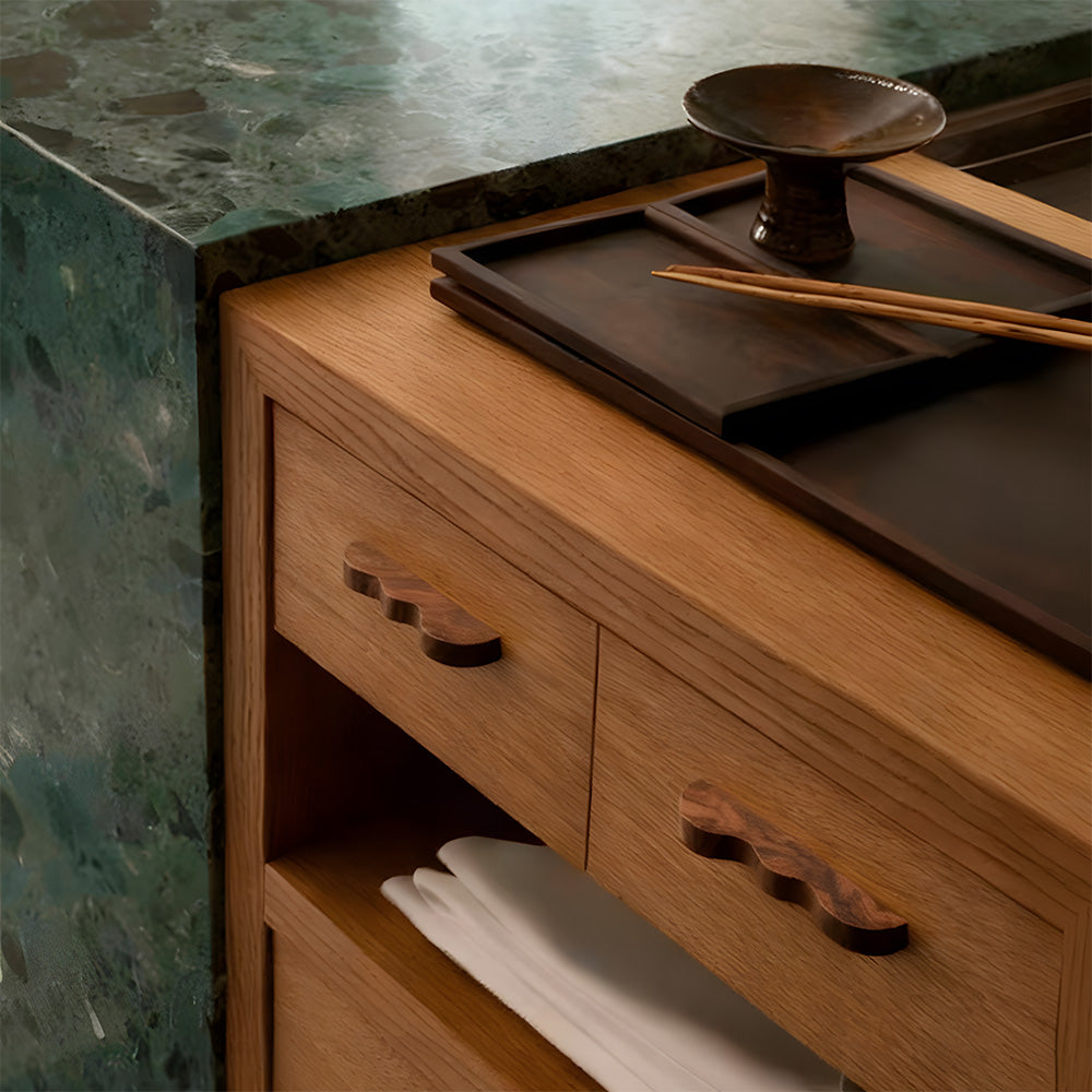 Wavy wood cabinet handle black walnut pulls on a wooden sideboard